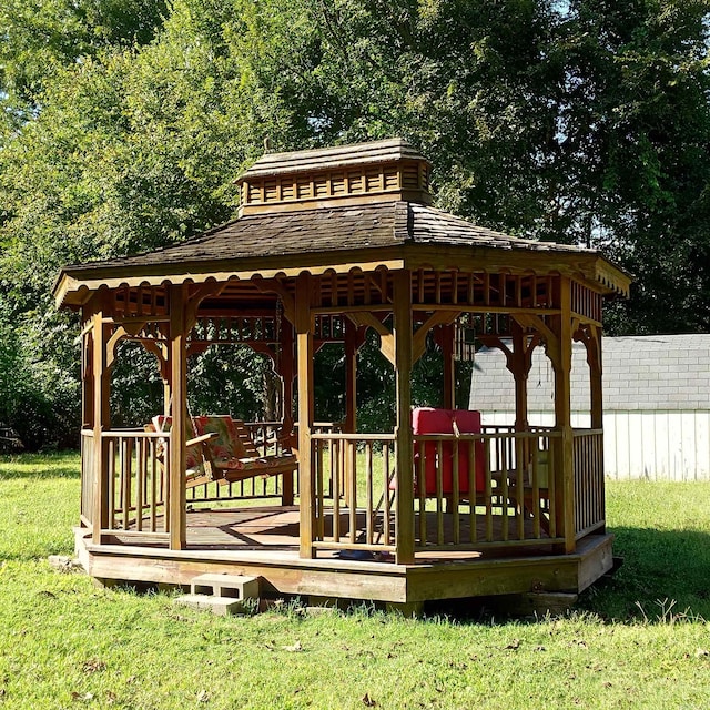 wooden deck with a gazebo and a yard