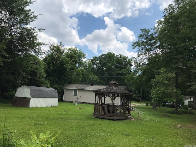 view of yard with a gazebo, a storage shed, and an outbuilding