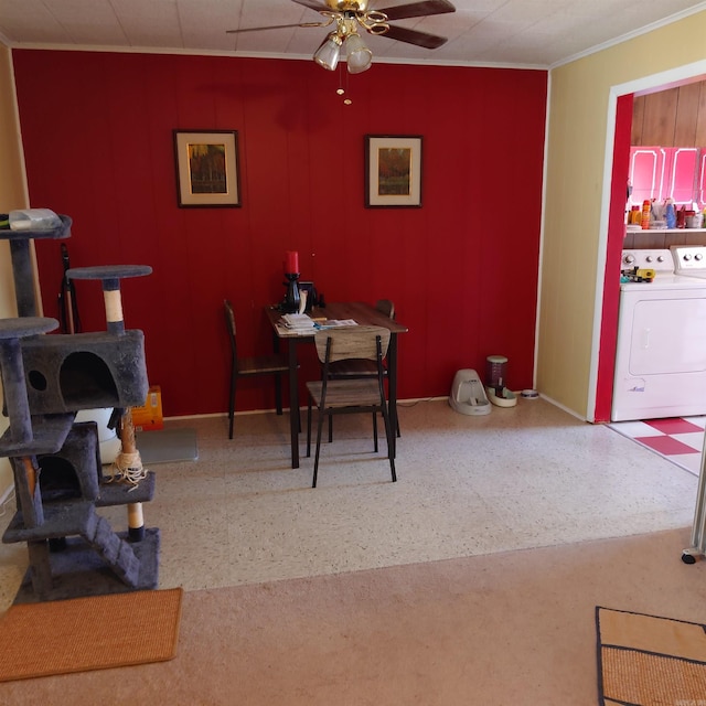 dining area featuring speckled floor, washer / clothes dryer, a ceiling fan, and baseboards