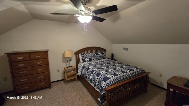 bedroom featuring visible vents, baseboards, light colored carpet, and vaulted ceiling