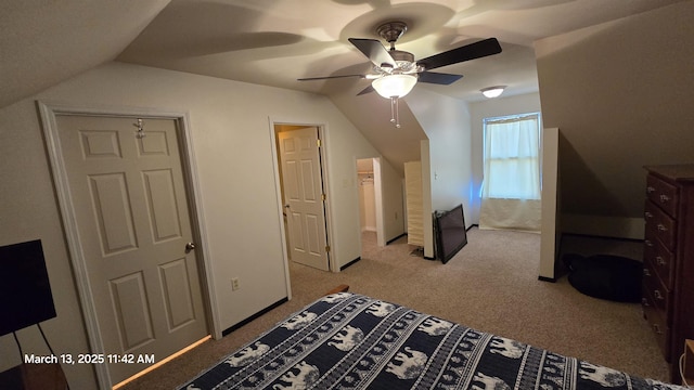 carpeted bedroom with a ceiling fan and lofted ceiling