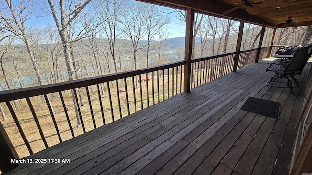 wooden terrace featuring a ceiling fan