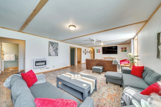 living room with baseboards, wood finished floors, ceiling fan, and heating unit