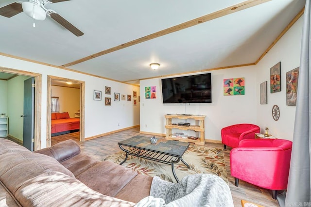 living area with crown molding, baseboards, a ceiling fan, and wood finished floors