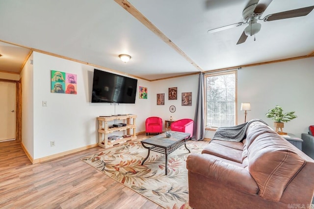 living area with crown molding, light wood finished floors, baseboards, and ceiling fan