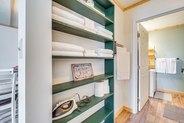 interior space featuring baseboards and wood finished floors