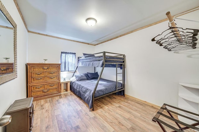 bedroom with light wood finished floors and ornamental molding