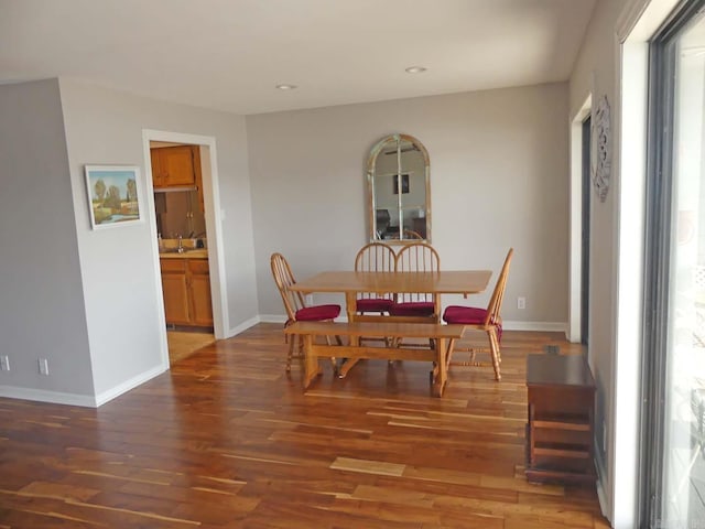 dining space with recessed lighting, baseboards, and wood finished floors