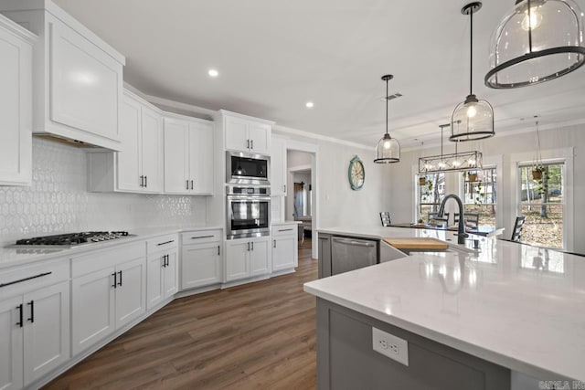 kitchen with visible vents, decorative backsplash, appliances with stainless steel finishes, dark wood-style floors, and white cabinets