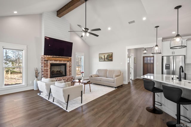 living room with a ceiling fan, visible vents, high vaulted ceiling, dark wood finished floors, and beam ceiling