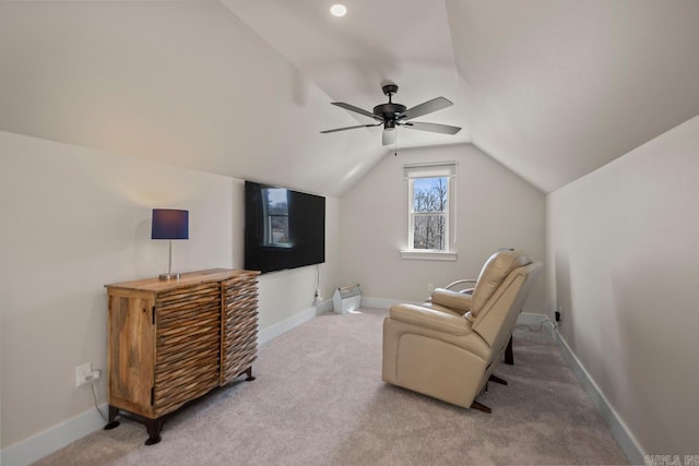 sitting room featuring lofted ceiling, baseboards, and carpet floors