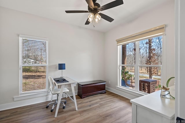 office space featuring light wood-style flooring, baseboards, and a ceiling fan