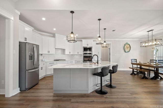 kitchen with appliances with stainless steel finishes, white cabinets, and light countertops