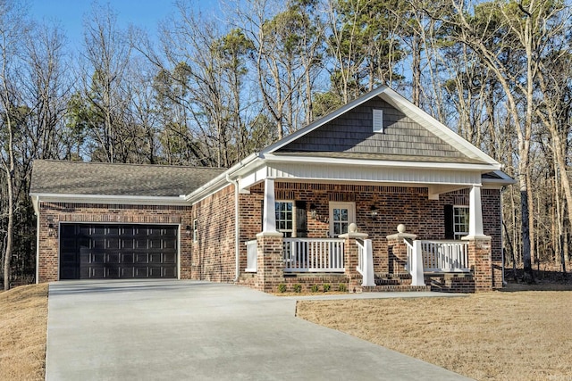 view of front of property featuring brick siding, a shingled roof, a porch, a garage, and driveway