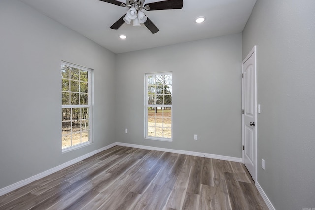 spare room featuring recessed lighting, ceiling fan, baseboards, and wood finished floors