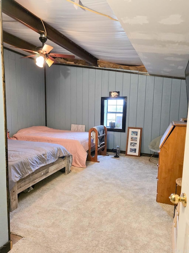 carpeted bedroom with beam ceiling and ceiling fan