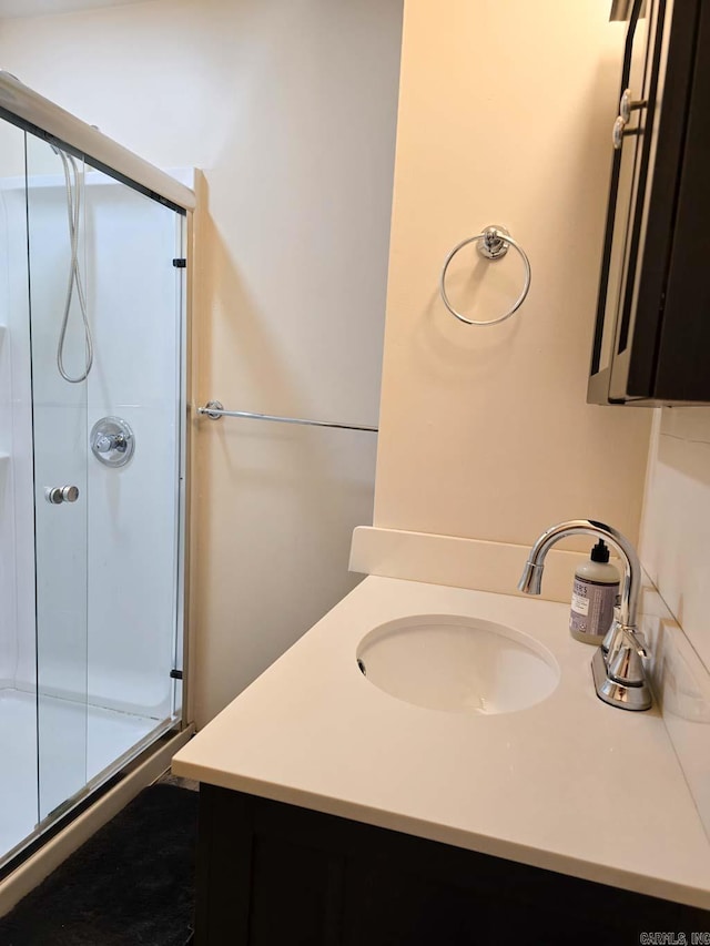 full bath with a shower stall and vanity