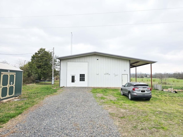 view of pole building with a yard