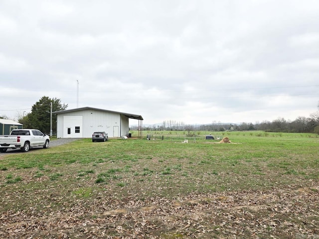 view of yard featuring an outbuilding and a garage