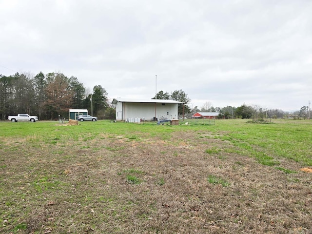 view of yard with an outbuilding and a pole building