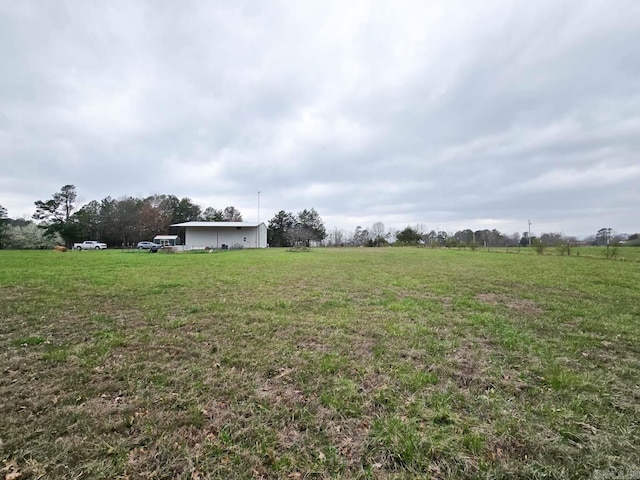 view of yard with a rural view