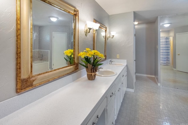 bathroom featuring a sink, baseboards, and double vanity