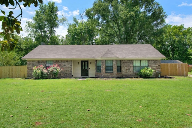 ranch-style home with a front lawn, fence, and brick siding