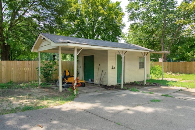 bungalow-style house featuring a carport and fence