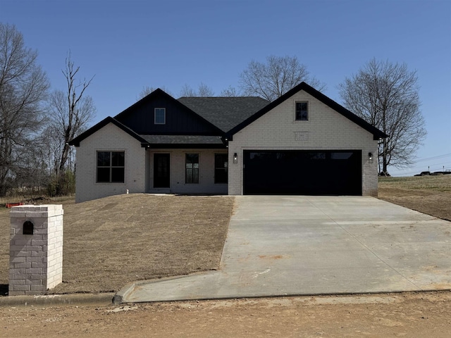 view of front facade with brick siding, an attached garage, and concrete driveway