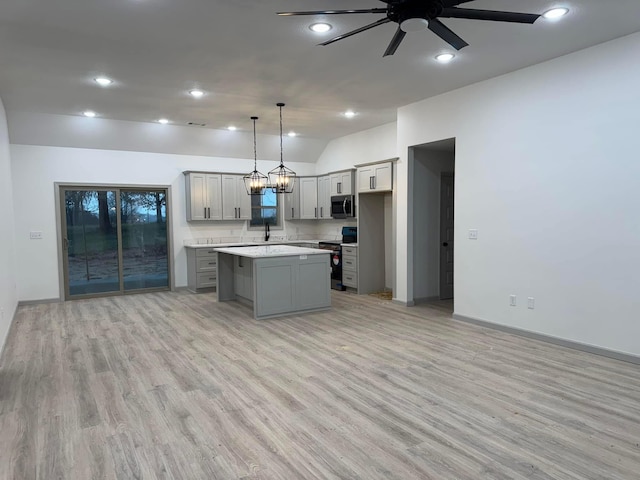 kitchen featuring black range with electric stovetop, gray cabinetry, stainless steel microwave, light countertops, and ceiling fan