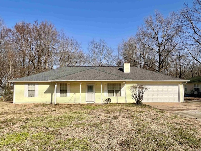 view of front of home with a shingled roof, a front lawn, an attached garage, and a chimney