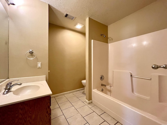 full bathroom with vanity,  shower combination, tile patterned flooring, a textured ceiling, and toilet