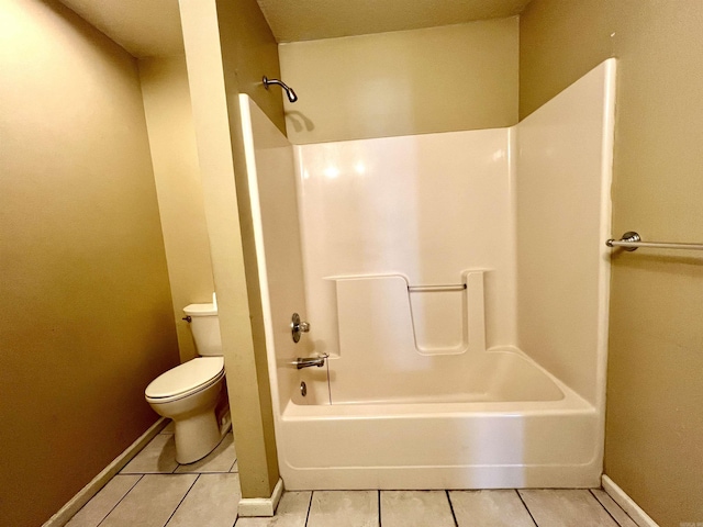 bathroom with tile patterned flooring, toilet, shower / bathtub combination, and baseboards