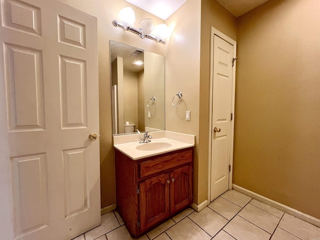 bathroom with tile patterned floors, visible vents, baseboards, and vanity