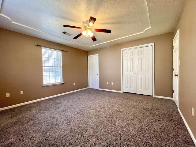 unfurnished bedroom featuring carpet, baseboards, and a textured ceiling