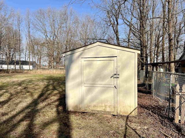 view of shed featuring fence