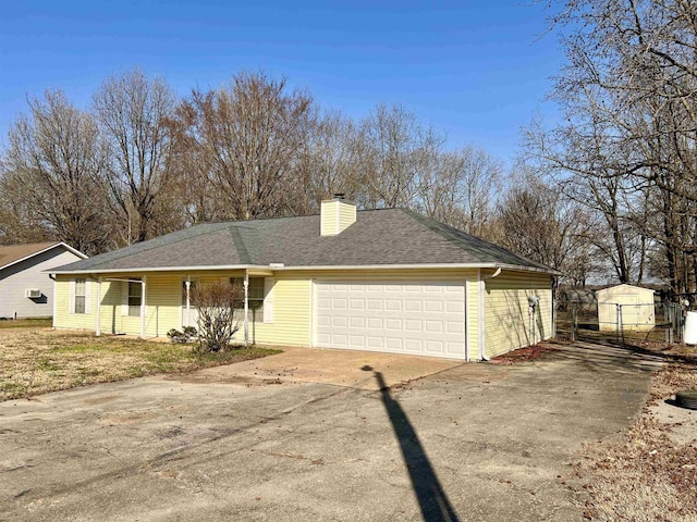 view of front of home featuring a shingled roof, fence, concrete driveway, a chimney, and an attached garage