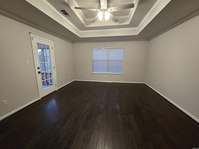 unfurnished room with visible vents, a raised ceiling, a ceiling fan, and wood finished floors