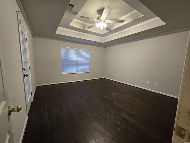 spare room featuring ceiling fan, ornamental molding, a tray ceiling, and hardwood / wood-style flooring