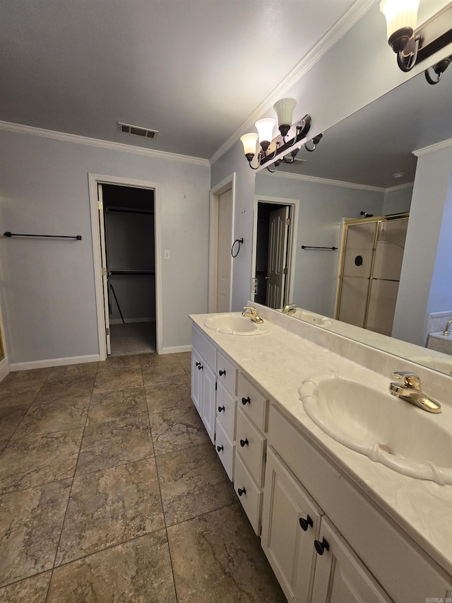 bathroom featuring visible vents, ornamental molding, a sink, a shower stall, and double vanity