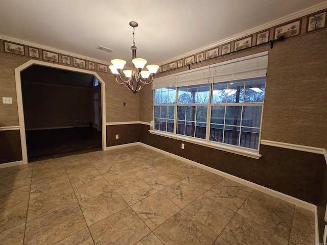 unfurnished dining area featuring visible vents, baseboards, arched walkways, and a chandelier