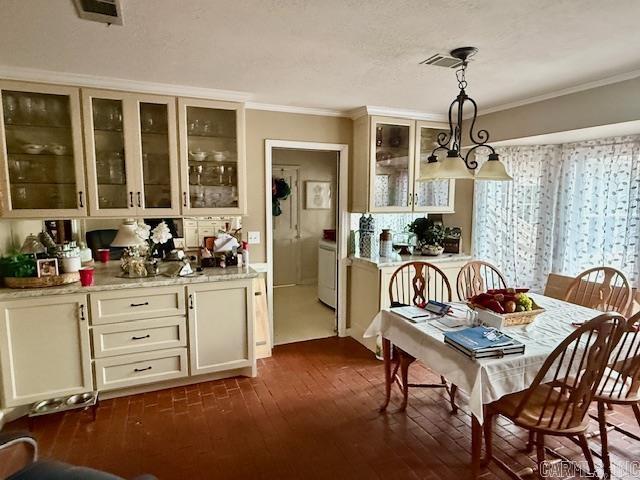 dining area with visible vents, dark wood-style flooring, and crown molding