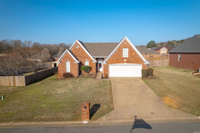 traditional-style home featuring fence, concrete driveway, an attached garage, a front yard, and brick siding