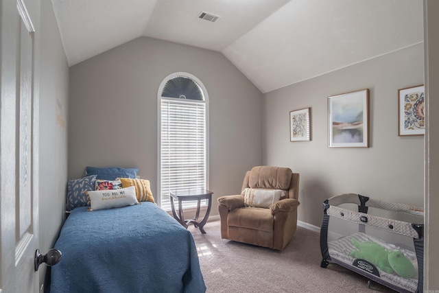 carpeted bedroom with lofted ceiling, baseboards, and visible vents