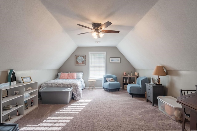 carpeted bedroom featuring a textured ceiling, a ceiling fan, and vaulted ceiling