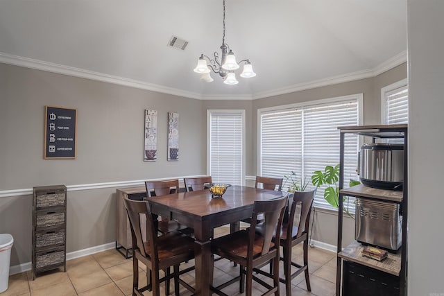 dining area with visible vents, crown molding, baseboards, light tile patterned floors, and a notable chandelier