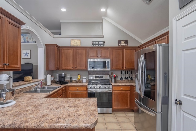 kitchen featuring light countertops, ornamental molding, appliances with stainless steel finishes, brown cabinetry, and a sink