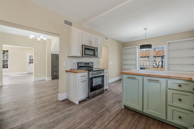 kitchen with visible vents, wooden counters, green cabinets, appliances with stainless steel finishes, and an inviting chandelier