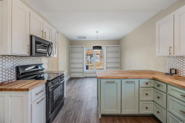 kitchen with stainless steel microwave, visible vents, black range with electric cooktop, butcher block counters, and a peninsula