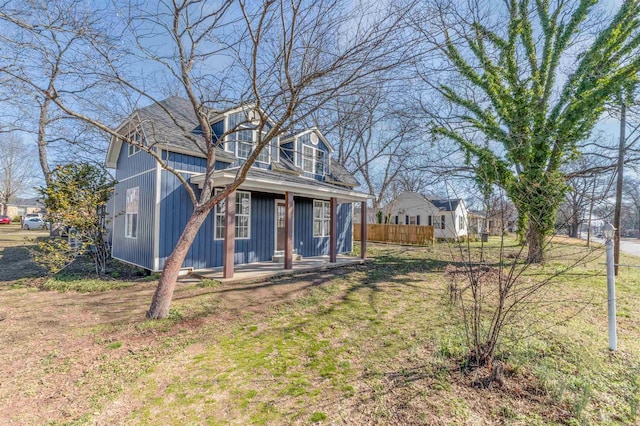 exterior space with board and batten siding and fence